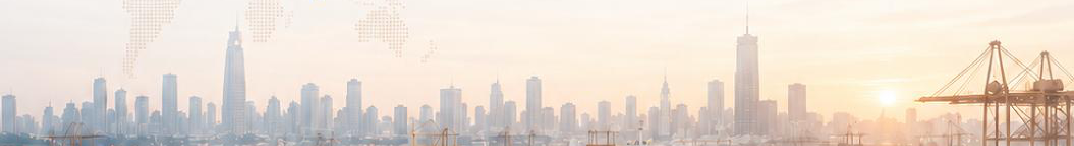 Container port and city skyline at sunset